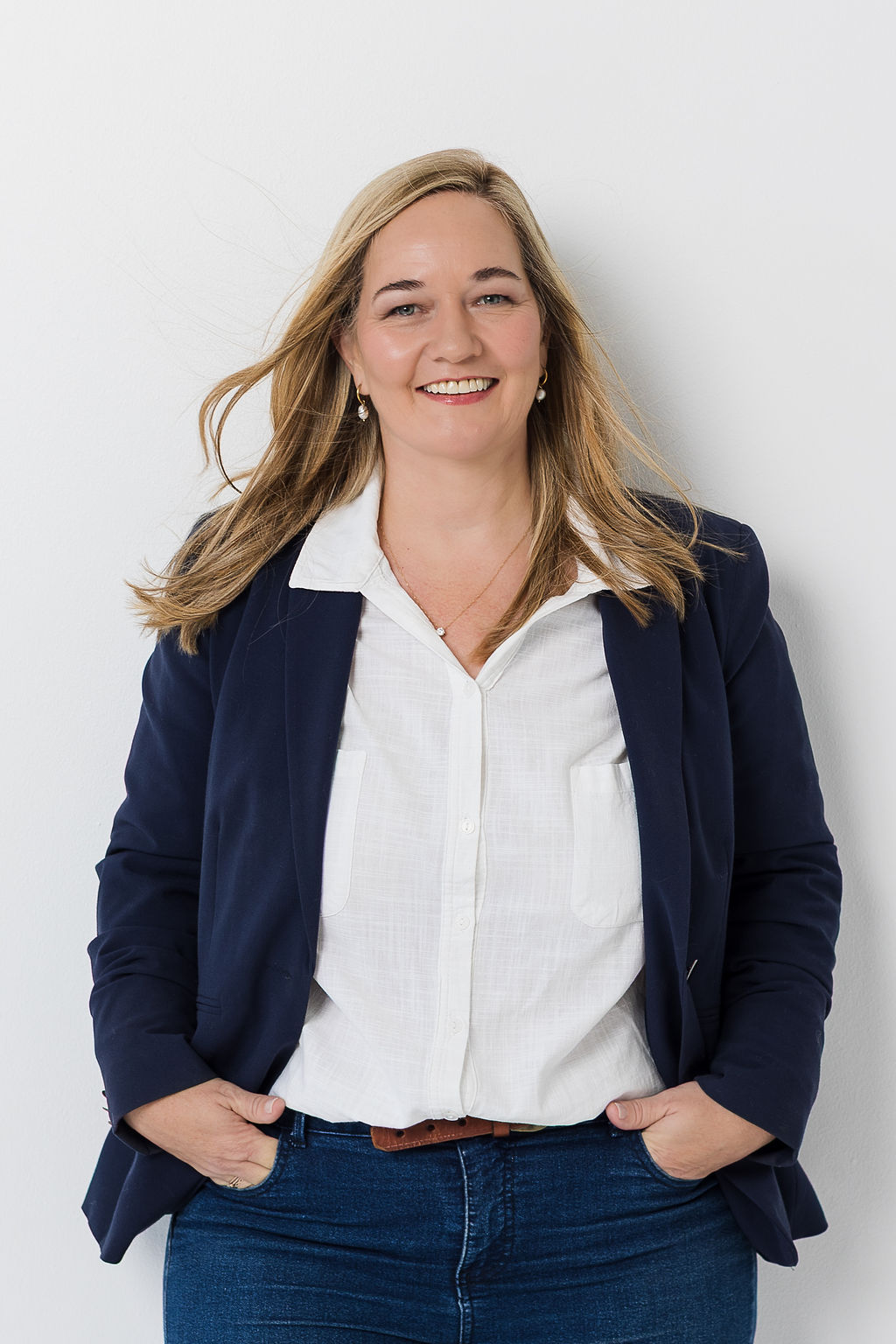 Kobie Abrie smiling in a navy blazer